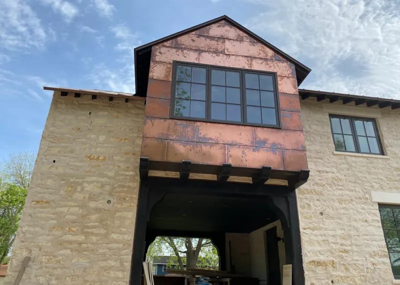Copper metal panel facade on a stone building for Skylight Installation in Morehead City