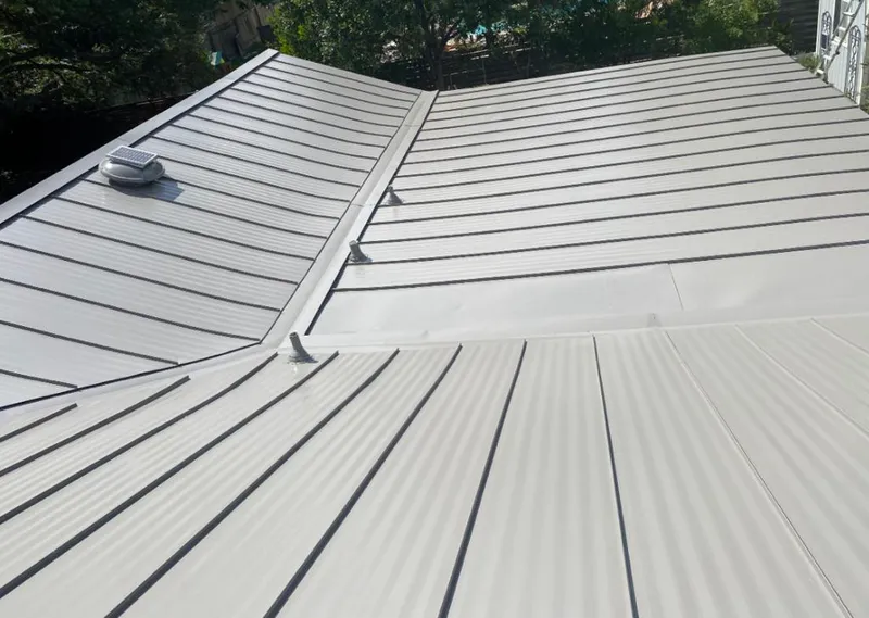 Solar attic fan installed on a metal roof for Roof Ventilation in Morehead City